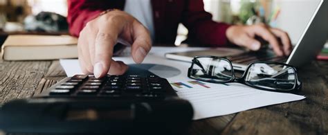 Organized bookkeeping workspace with laptop and financial documents
